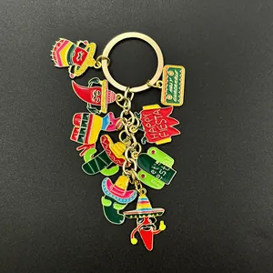 Detailed view of Mexican Fiesta enamel charms including chili and cactus on a golden keychain