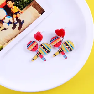 Detailed view of colorful Mexican fiesta maraca earrings with vibrant patterns and heart studs