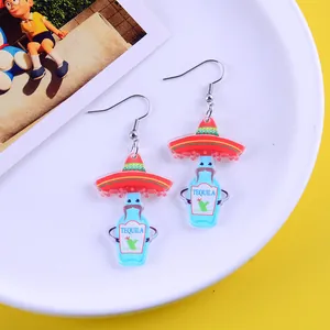 Close-up detail of cartoon Tequila bottle earrings with sombreros for Mexican party decor