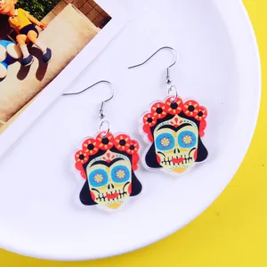Close-up detail of vibrant Mexican Day of the Dead sugar skull earrings with floral crown