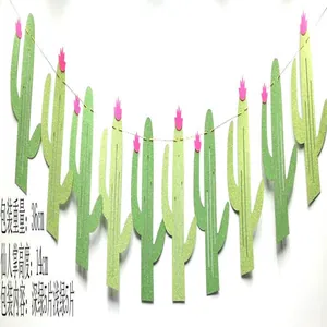 Detail view showing a glittery green cactus party banner decorated with pink flower accents