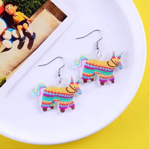 Close-up view of colorful Mexican pinata cartoon earrings for creative festival parties.