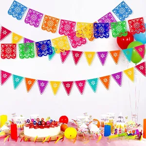 Vibrant Mexican party decoration set featuring felt papel picado banners balloons and cake