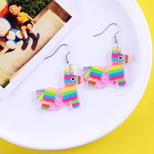 Macro detail view of colorful llama piñata earrings for Mexican carnival party accessories.
