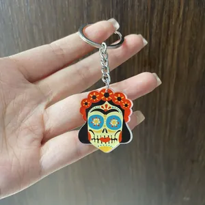 Handheld acrylic Mexican Day of the Dead skull keychain with colorful flower crown design