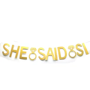 Golden glitter banner with 'She Said Yes' text and diamond ring for wedding party decor