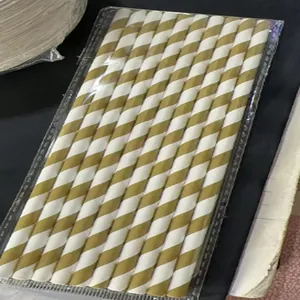 Gold and white striped biodegradable paper straws for festive party decorations.