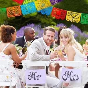 Vibrant Mexican Papel Picado banners displayed during an outdoor garden wedding party
