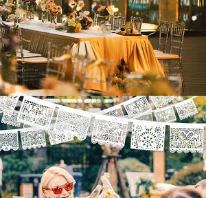 Detailed macro view of white felt Mexican Papel Picado banner for wedding and party