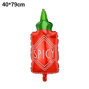 Detail view of red spicy hot sauce bottle foil balloon for Mexican party decor