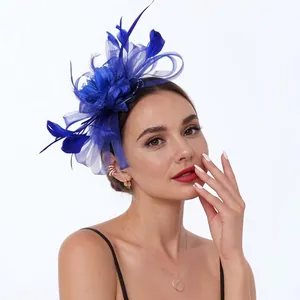 Close-up detail of a royal blue fascinator with feathers and mesh worn by model