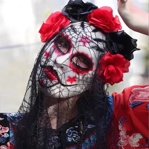 Detailed close-up of a Day of the Dead mask featuring red roses and a black lace veil