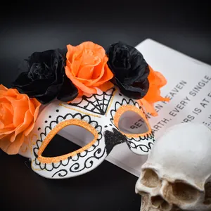 Détail rapproché du masque du Jour des Morts avec des roses en tissu orange et noires