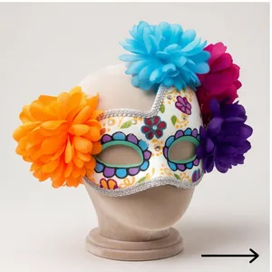 Detailed view of the Mexican Day of the Dead mask with colorful fabric flowers.