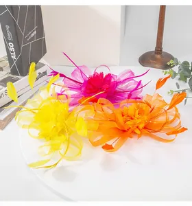 Detailed view of three colorful feather and mesh hair fascinators for formal events