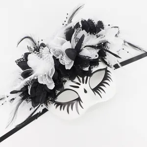 Detail view of Day of the Dead mask with elegant black and white floral crown and feathers