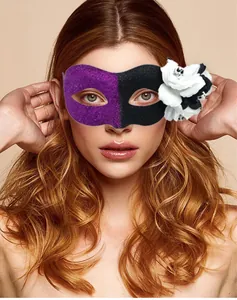Detail view of purple and black glitter masquerade mask with skull flower ornament