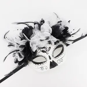 Detailed view of a Day of the Dead mask featuring elegant black and white flowers and feathers