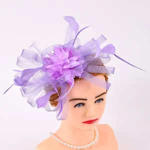 Elegant purple mesh fascinator with feathers for weddings and tea parties on mannequin