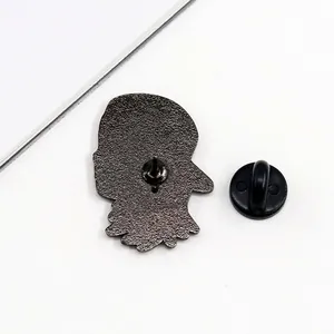 Detailed macro view of the back of a metal enamel pin with a black rubber clutch