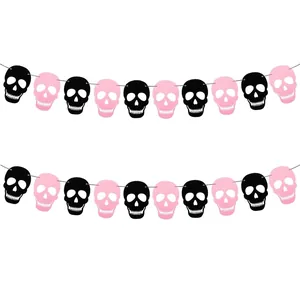 Close-up detail of black and pink paper skull garland with heart-shaped eye sockets