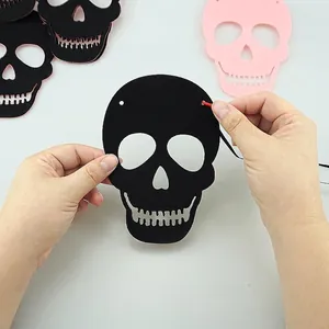 Detail of black glitter paper skull decoration for DIY Halloween banner assembly