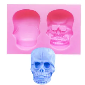 Detailed view showing Halloween skull silicone mold cavities and finished 3D resin skull