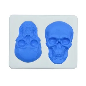 Close-up of a white silicone mold showing intricate skull details for Halloween fondant crafts