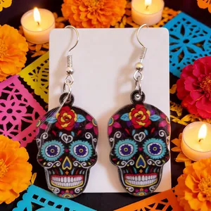Vibrant acrylic sugar skull earrings with colorful floral Day of the Dead pattern detail.