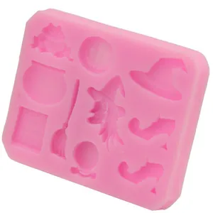 Close-up detail view of pink Halloween silicone mold featuring witch and broom shapes