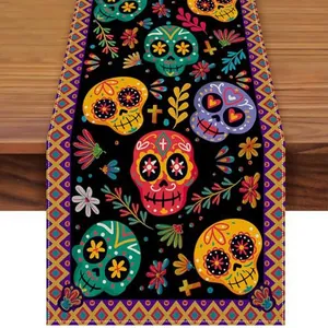 Vibrant Day of the Dead sugar skull and floral pattern details on black fabric table runner