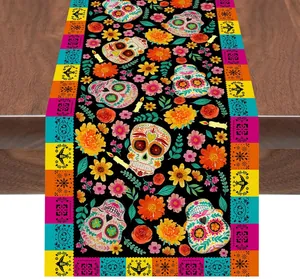 Close-up of sugar skull and marigold patterns on a decorative Mexican table runner