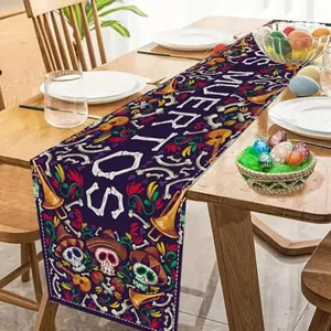 Detail view of the Dia de los Muertos sugar skull patterned festive table runner
