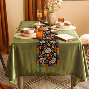 Sugar skull table runner decorates a dining table for Day of the Dead celebrations