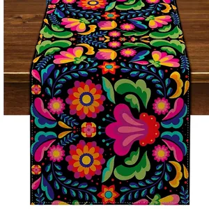 Detailed view of a Mexican floral table runner featuring vibrant Bohemian patterns on linen.