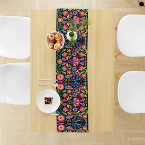 Close-up of linen Mexican table runner with vibrant floral carnival theme pattern.
