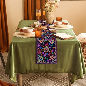 Detailed view of Mexican Day of the Dead table runner with vibrant skull patterns.