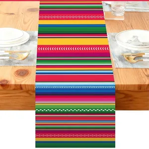 Close-up detail of vibrant Mexican Bohemian striped pattern on linen table runner cloth