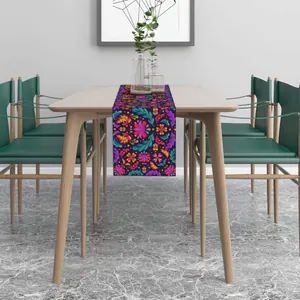 Detailed view of Mexican Day of the Dead floral table runner on a wooden dining table