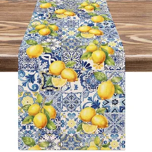 Macro detail of bohemian linen table runner featuring lemon print and blue tile pattern