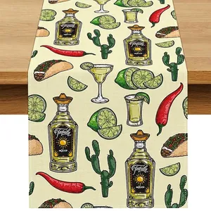 Close-up detail of a Mexican themed linen table runner featuring Tequila bottles and lime prints