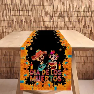 Close-up of a Dia de los Muertos table runner featuring festive skull and marigold prints
