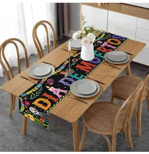 Festive Mexican Day of the Dead linen table runner shown on a wooden dining table