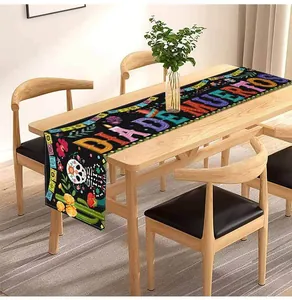Linen table runner with colorful Dia de Muertos skull print on wooden dining table