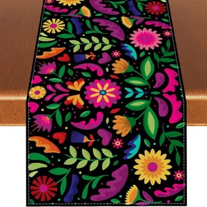 Top-down view of colorful Mexican floral table runner on a dark wood table