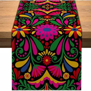 Colorful Mexican fiesta table runner with vibrant floral patterns on a wooden table.