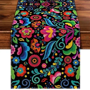 Detailed view of Mexican Bohemian linen table runner with vibrant floral print on black