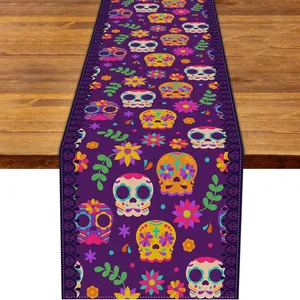 Detail view of Day of the Dead table runner with vibrant sugar skull and floral print texture.