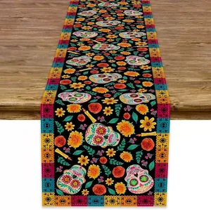 Detail view of linen table runner featuring vibrant Mexican Day of the Dead sugar skull art