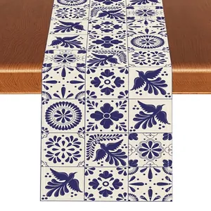 Close-up of Mexican Bohemian linen table runner with blue floral and bird print pattern.